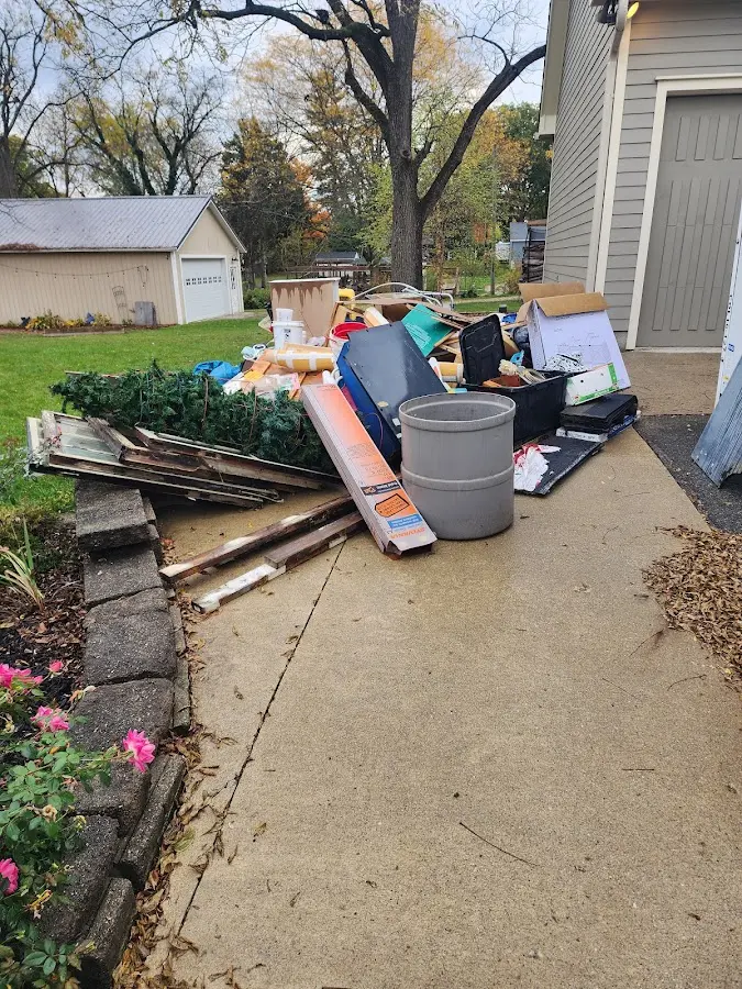 Dumpster being loaded with debris for Commercial Dumpster Rental in Bridgton